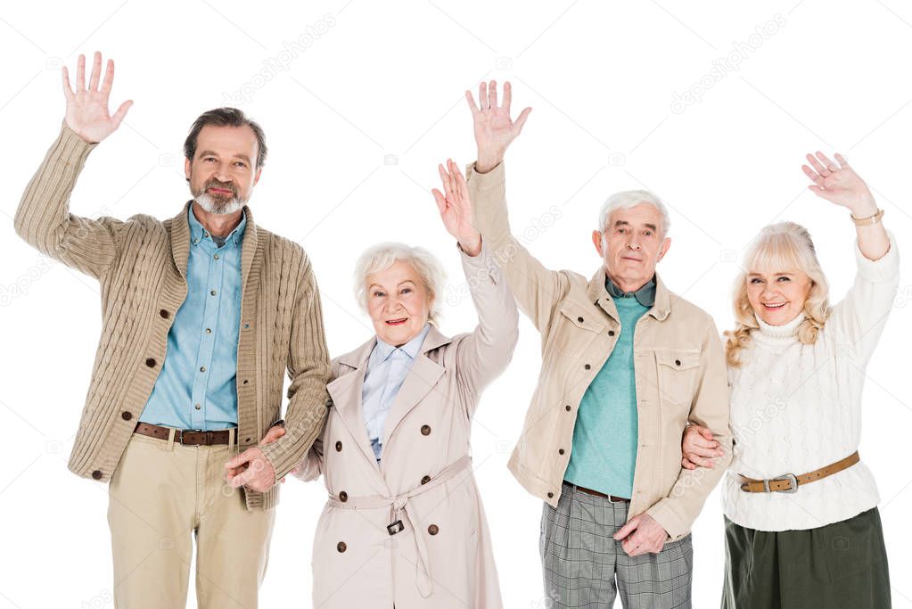 cheerful retired people waving hands isolated on white