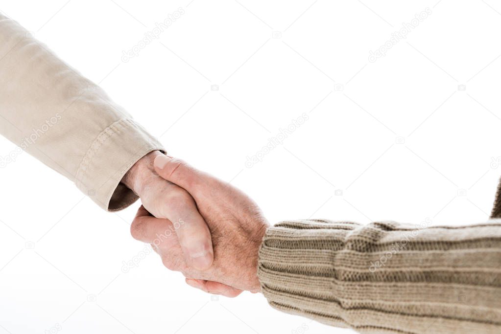 cropped view of retired friends shaking hands isolated on white