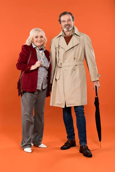 Elegante Pareja Ancianos Pie Sonriendo Sobre Fondo Naranja — Foto de Stock