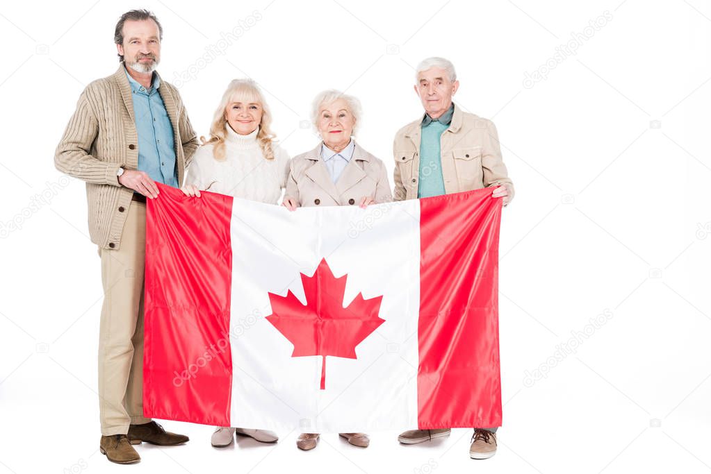 happy senior people holding flag of canada isolated on white