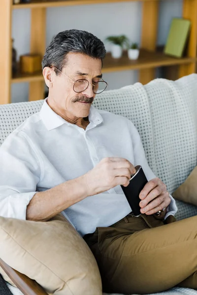 Senior Man Glasses Looking Alcohol Flask Home — Stock Photo, Image