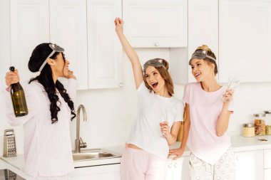 tezahürat ve şampanya ile pijama partisi sırasında kutluyor güzel çok kültürlü kızlar