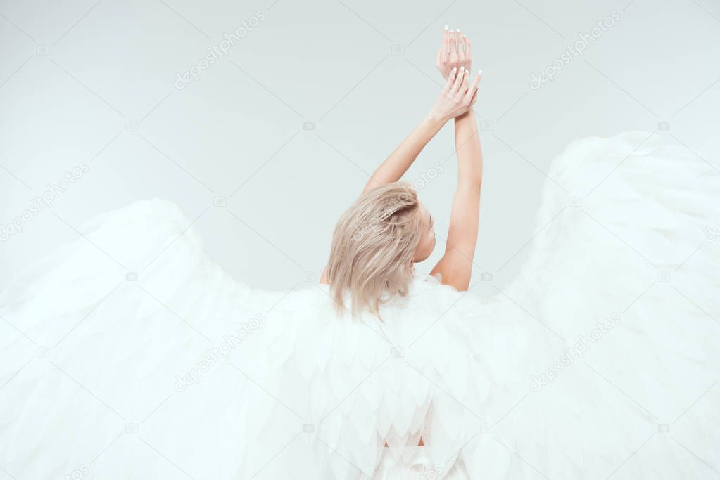 back view of woman with angel wings posing isolated on white with copy space