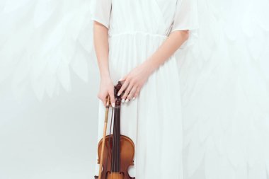 cropped view of woman in angel costume with wings holding violin and bow isolated on white clipart