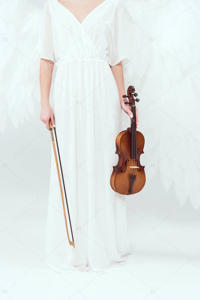 cropped view of woman in angel costume with wings holding violin and bow isolated on white