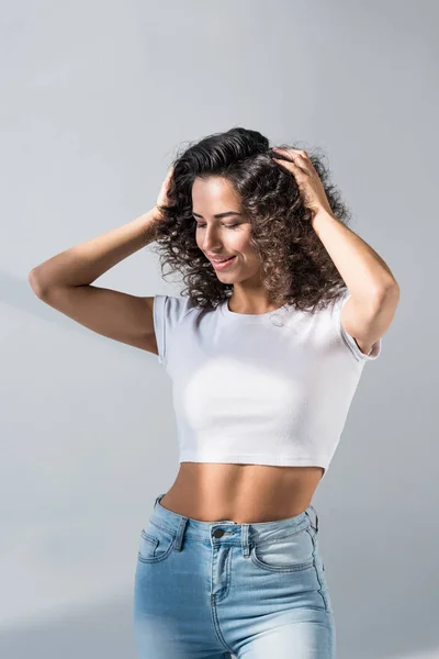 Smiling Woman Crop Top Jeans Touching Hair Grey Background — Stock Photo, Image