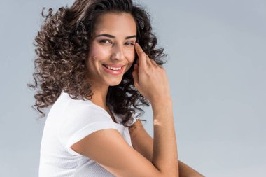 Gri izole kamera bakarak mutlu kıvırcık kız