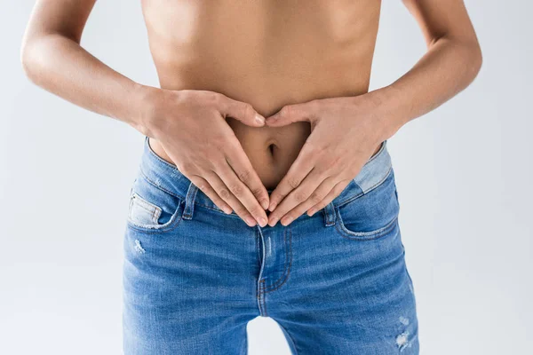 Vista Recortada Mujer Jeans Mostrando Símbolo Del Corazón Sobre Fondo — Foto de Stock