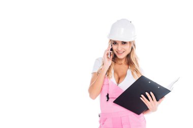 handy woman in pink uniform with paper tablet talking on smartphone isolated on white clipart