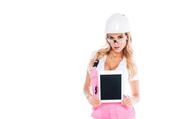 attractive handy woman in pink uniform and glasses holding digital tablet isolated on white