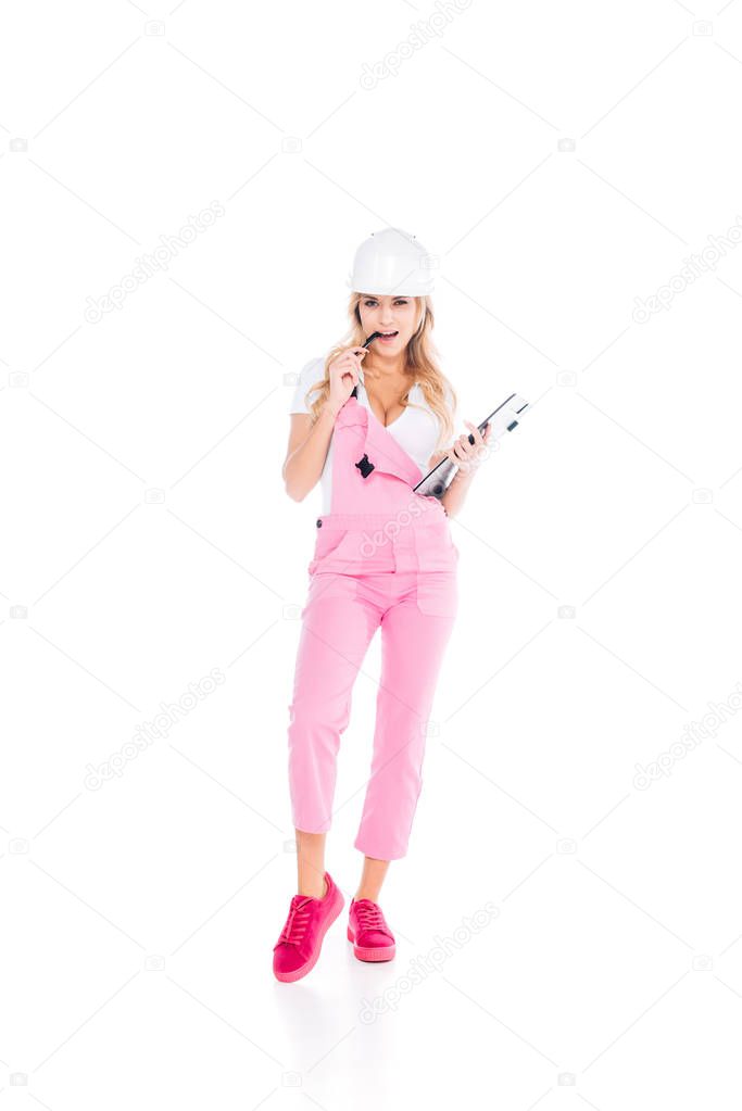 handy woman in pink overalls, hardhat with paper clipboard pen on white background