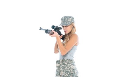 attractive militarywoman in grey t-shirt, camouflage pants and cap holding weapon isolated on white clipart