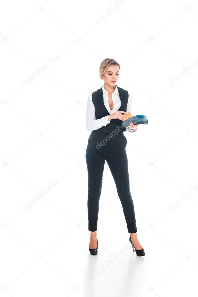 blonde attractive waitress in black uniform doing transaction with credit card and  terminal isolated on white