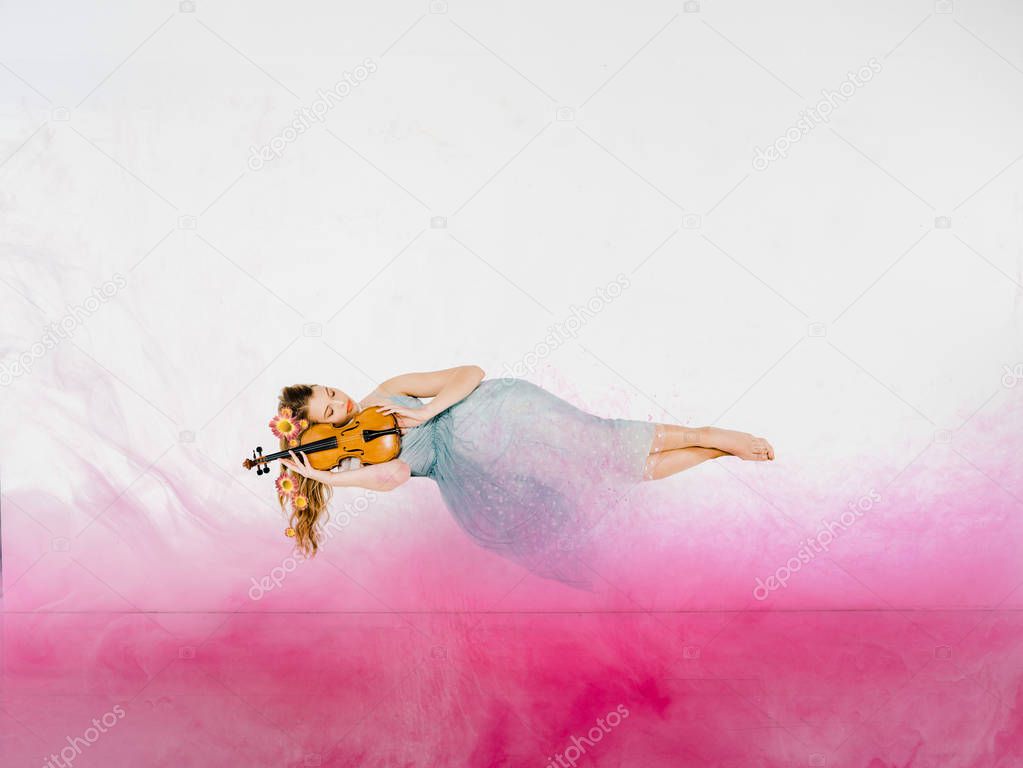 floating girl in blue dress sleeping on violin with pink cloud illustration