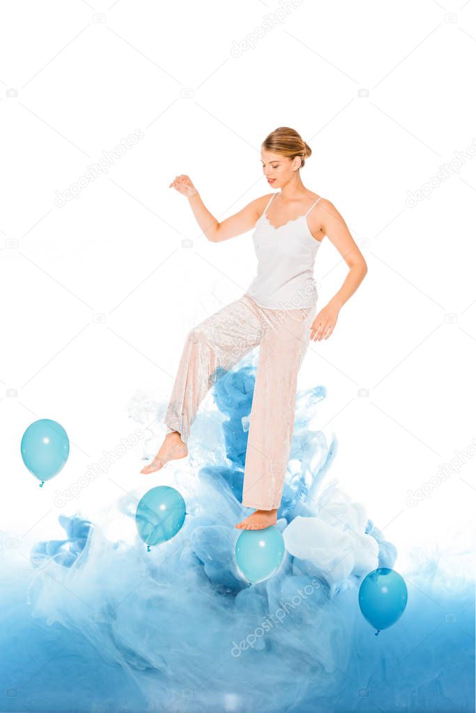 girl in pyjamas standing on blue ballons with cloud illustration 