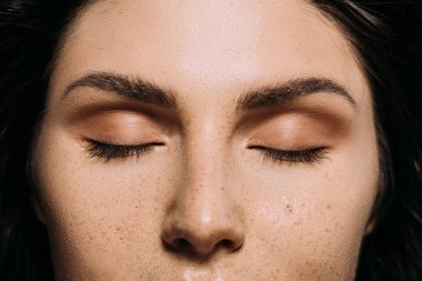 close up view of girl with closed eyes and freckles on face  clipart