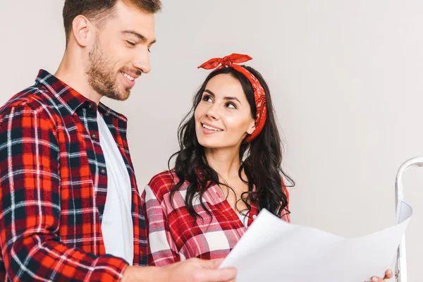 Cheerful Woman Looking Boyfriend While Standing Boyfriend Holding Blueprint Home — Stock Photo, Image