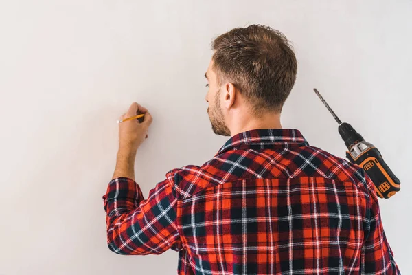 Man Holding Drill Pencil Hands While Standing Wall — Stock Photo, Image