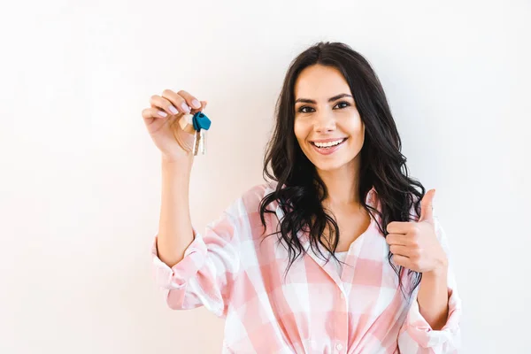 Cheerful Woman Holding Key While Showing Thumb Isolated White — Stock Photo, Image