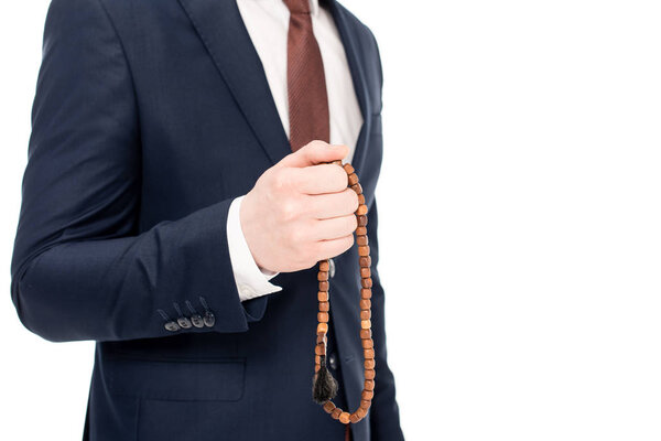cropped view of businessman praying and holding rosary beads isolated on white