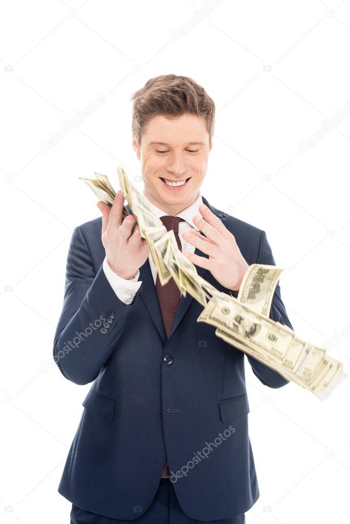 happy successful businessman throwing up dollar banknotes isolated on white