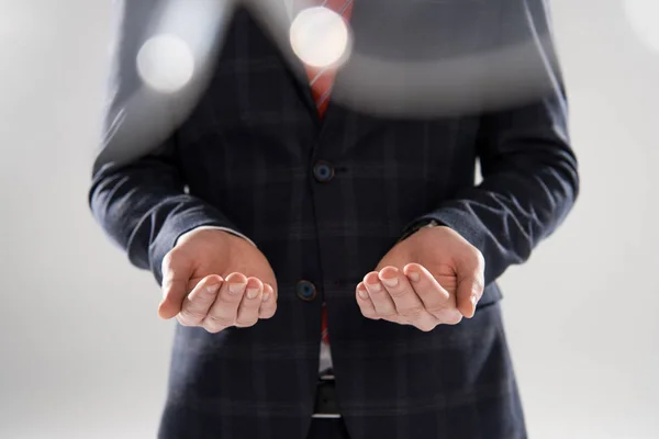 Cropped View Young Businessman Holding Something Palms Grey — Stock Photo, Image