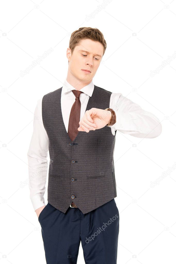 handsome stylish businessman looking at watch isolated on white