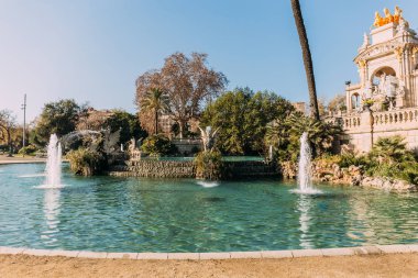 beautiful architectural ensemble and lake with fountains in parc de la ciutadella, barcelona, spain clipart