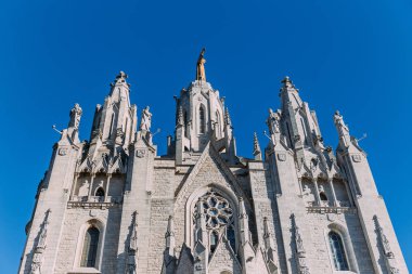  exterior of temple expiatori del sagrat on clear blue sky background, barcelona, spain clipart