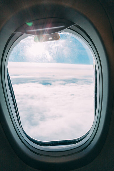 plane window with blue sunny sky view