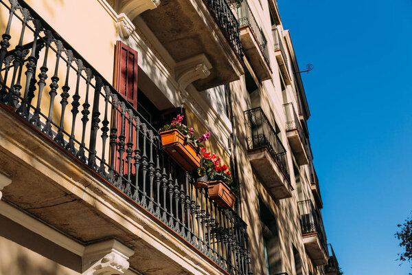selective focus of beautiful house with balconies in barcelona, spain