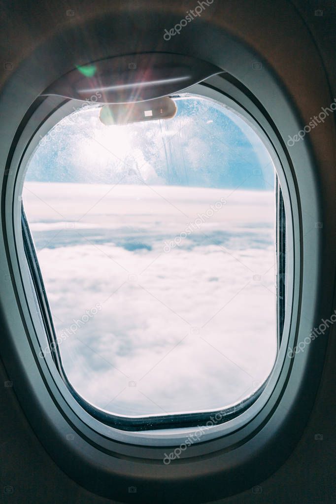 plane window with blue sunny sky view