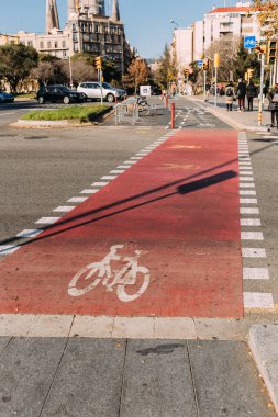 BARCELONA, SPAIN - DECEMBER 28, 2018: road with bikeway, parked cars and buildings clipart