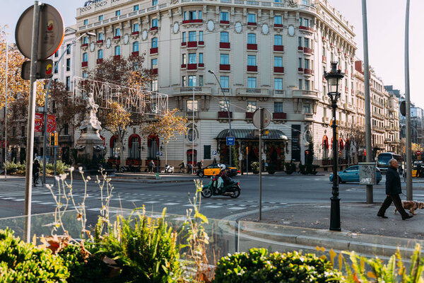 BARCELONA, SPAIN - DECEMBER 28, 2018: busy street with beautiful house on crossroad