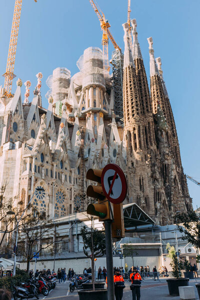 BARCELONA, SPAIN - DECEMBER 28, 2018: selective focus of Temple Expiatori de la Sagrada Familia, one of the most famous buildings of Barcelona, built by Antoni Gaudi, on blue sky background