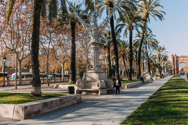 BARCELONA, SPAIN - DECEMBER 28, 2018: wide alley with lanterns in Parc de la Ciutadella leading to Arc de Triomf 