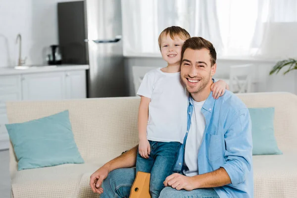 Happy Father Preschooler Son Hugging Looking Camera Home — Stock Photo, Image