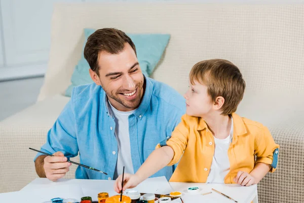 Happy Father Preschooler Son Holding Paintbrushes Drawing Home — Stock Photo, Image