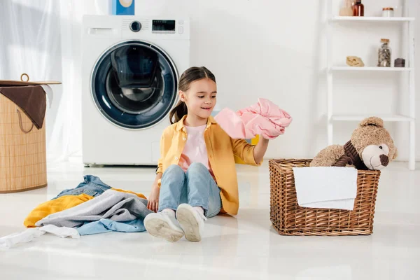 Child Yellow Shirt Jeans Sitting Putting Clothes Basket Laundry Room — Stock Photo, Image
