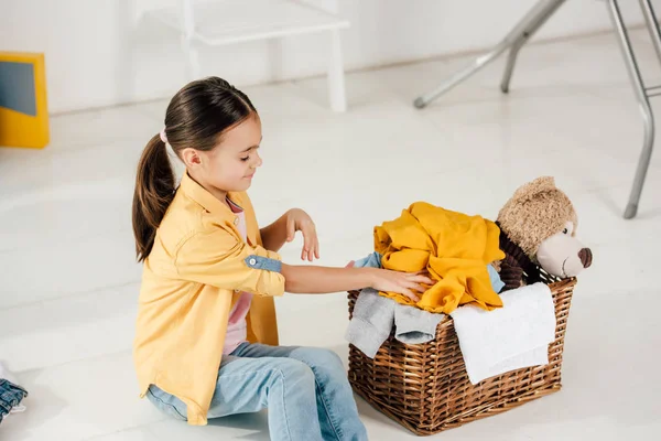 Child Sitting Putting Clothes Basket Home — Stock Photo, Image