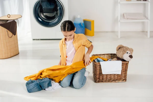 Child Yellow Shirt Jeans Sitting Basket Holding Clothes Laundry Room — Stock Photo, Image