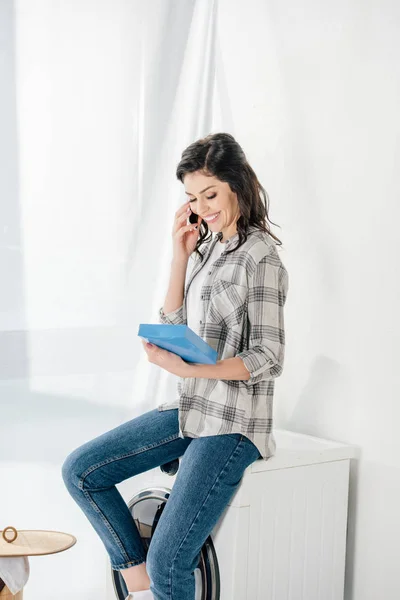 Woman Sitting Washer Talking Smartphone Holding Washing Powder Laundry Room — Stock Photo, Image