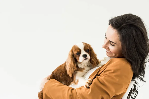 Excited brunette woman in brown jacket holding dog with smile isolated on white — Stock Image Excited Brunette Woman Brown Jacket Holding Dog Smile Isolated White Royalty Free Stock Photos