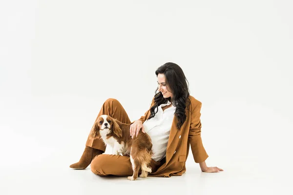 Elegant pregnant woman sitting on floor and stroking dog on white background — Stock Image Elegant Pregnant Woman Sitting Floor Stroking Dog White Background Stock Image