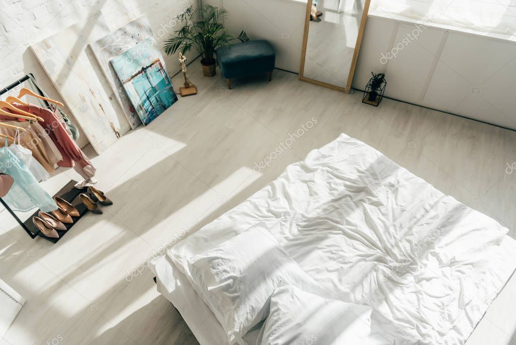 overhead view of modern white bedroom with bed and stylish wardrobe 