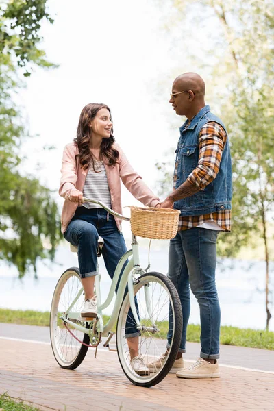 Happy African American Man Looking Cheerful Girlfriend Riding Bicycle — Stock Photo, Image