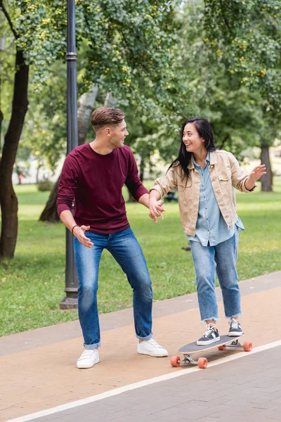 Handsome Man Looking Attractive Girlfriend Riding Longboard — Stock Photo, Image