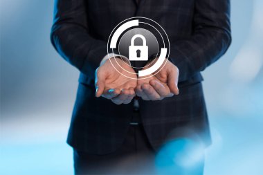 partial view of businessman with outstretched hands and internet security icon above on blue background clipart