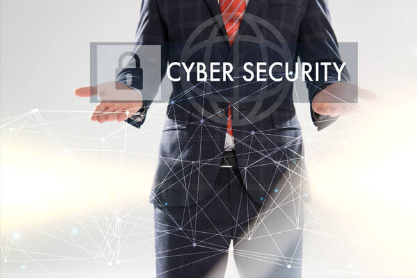 cropped view of businessman in suit pointing with hands at cyber security illustration in front 