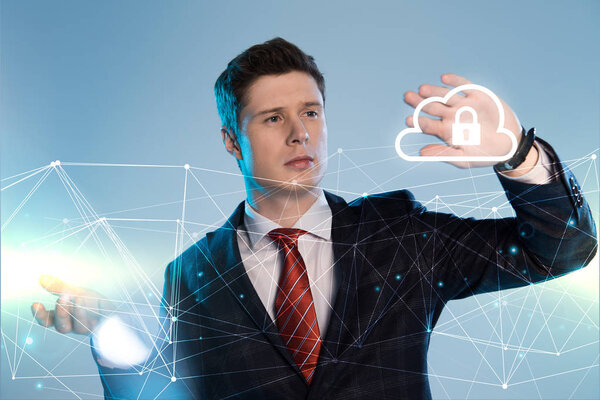 handsome businessman in suit pointing at network and lock in cloud illustration in front on blue background